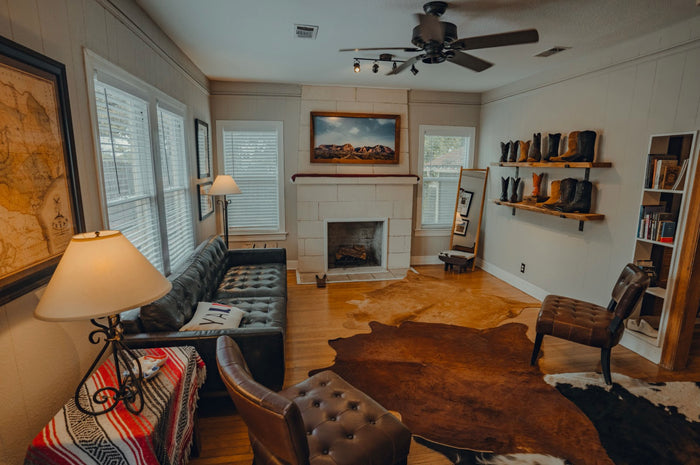 Inside Chisos HQ: a leather sofa, fireplace, cowhide rug and shelves of cowboy boots