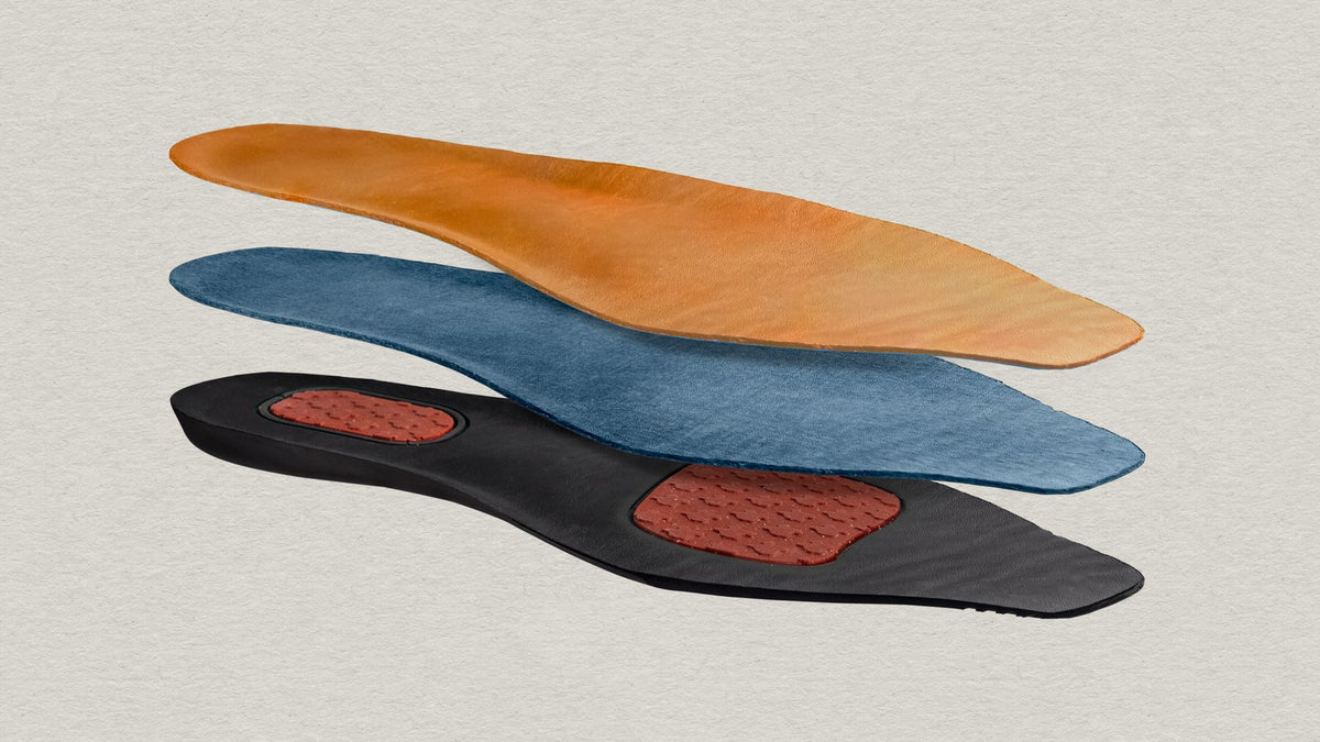 The Chisos comfort insole shown in three separated layers: leather top, cushioning layer and base with gel pads at the heel and ball