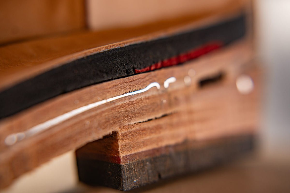 The steel shank visible as a bright line between the leather insole and the sole